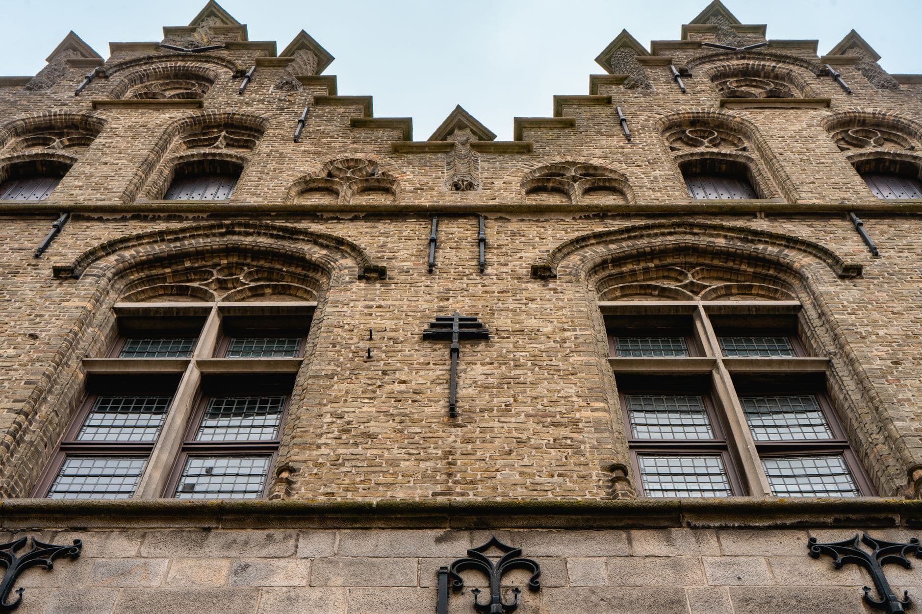 Gevel van een historisch gebouw in natuursteen en baksteen in Ieper